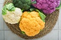 Colorful cauliflower. Various sort of cauliflower on stone tiles gray concrete background. Purple, yellow, white and green color c Royalty Free Stock Photo