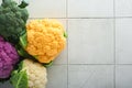 Colorful cauliflower. Various sort of cauliflower on stone tiles gray concrete background. Purple, yellow, white and green color c Royalty Free Stock Photo