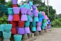 Colorful cement flower pots stacked up on the side of road