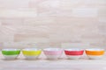 Colorful Ceramic Bowls Stacked On Each Other on Wood Background Royalty Free Stock Photo