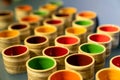 Colorful ceramic cups lined up in a row. Selective focus