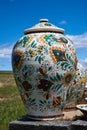 Colorful ceramic handmade pot on a blue sky background