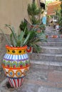 Colorful ceramic pot, Sicilian ceramics with a flower inside, with a cactus, the pot on the stairs Royalty Free Stock Photo