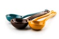 Colorful ceramic spoons in blue, brown, and yellow displayed on white background Royalty Free Stock Photo