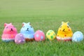 Colorful ceramic three rabbit with eggs on top grass on Easter Royalty Free Stock Photo