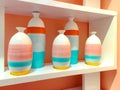 Colorful ceramic vases on a shelf