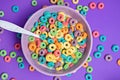 Colorful cereal in bowl on a purple background Royalty Free Stock Photo