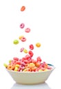 Colorful cereal falling on a white bowl