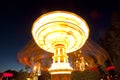 Colorful chain swing carousel in motion at amusement park at night. Royalty Free Stock Photo