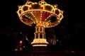 Colorful chain swing carousel in motion at amusement park at night. Royalty Free Stock Photo