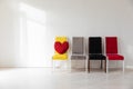 Four colorful chairs in the interior of a white empty room Royalty Free Stock Photo