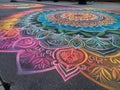 Colorful chalk art mandala on sidewalk