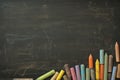 Colorful chalks arranged on blackboard, ideal for educational settings