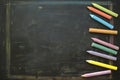 Colorful chalks arranged on blackboard, ideal for educational settings