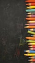Colorful chalks arranged on blackboard, ideal for educational settings