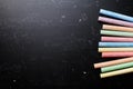 Colorful chalks on blackboard for back to school theme.