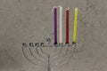 Colorful Chanukah candles lit in the menorah, candle light