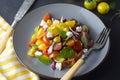 Colorful cherry tomatoes and basil salad on a plate, dark background. Healthy, summer food Royalty Free Stock Photo