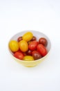 Colorful cherry tomatoes in a jellow bowl. Royalty Free Stock Photo