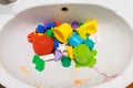 Colorful children bath toys painted with watercolor paint in sink