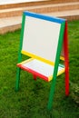 Colorful children easel with blank canvas