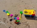 Colorful children`s beach toys on sand background Royalty Free Stock Photo