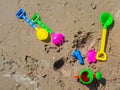 Colorful children`s beach toys on sand background Royalty Free Stock Photo