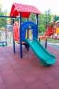 Colorful children's Playground with slides and swings outdoors in the Park in summer Royalty Free Stock Photo