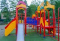 Colorful children's Playground with slides and swings outdoors in the Park in summer Royalty Free Stock Photo