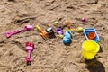Colorful children's toys scattered on the sand at the beach