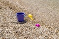 Colorful children's toys scattered on the sand at the beach