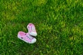 Colorful children sandals on playground grass photo