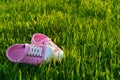 Colorful children sandals on playground grass photo