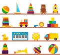 Colorful children toys on wooden shelves. Cubes, whirligig, duck, ball rattle, truck, pyramid, pipe, bear, ball, rocket,