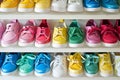 colorful childrens shoes on a white horizontal rack Royalty Free Stock Photo