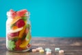 Colorful childs sweets and treats in jar on wooden table