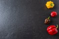 Colorful chili peppers isolated on a slate plate Royalty Free Stock Photo