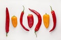 Colorful chili peppers on white background. Red, yellow, hot and sweet bell peppers. Spicy food ingredient