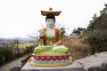 Colorful chinese god figure and deity angel buddha statue on stone stairs go to Sanbangsan mountain for korean people travelers Royalty Free Stock Photo