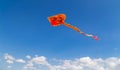 Colorful chinese kite flying in the blue sky with white clouds Royalty Free Stock Photo