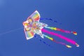 Colorful chinese kite flying in the blue sky with white clouds Royalty Free Stock Photo