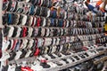 Colorful Chinese sneakers are hung in rows in the market. Sale of fashionable sneakers. Russia, Abakan 23.09.2019.