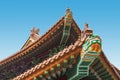 Colorful chinese temple roof detail with a dragon and blue sky background.