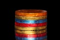 Chocolate coins stacked on black background