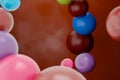 Colorful chocolate dragee candies floating against chocolate background, showcasing variety candy is perfectly round