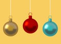Colorful Christmas ball ornament hanging on yellow background. New Year`s Eve decoration golden red shiny convolution lines hang Royalty Free Stock Photo