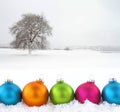 Colorful Christmas balls on snowfield Royalty Free Stock Photo