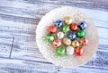 Colorful Christmas balls in white bowl Royalty Free Stock Photo