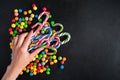 Colorful Christmas candies with female hand which want to take candy canes Royalty Free Stock Photo