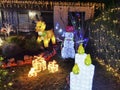 Colorful Christmas decorations in a front yard at night with various illuminated objects Royalty Free Stock Photo